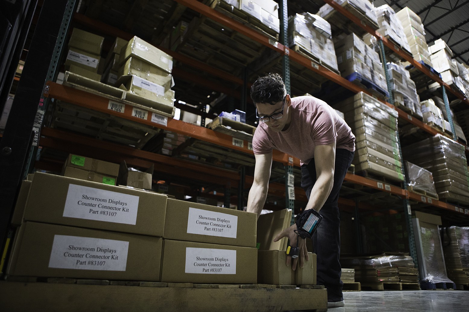 Warehouse operator moving labelled stock during replenishment