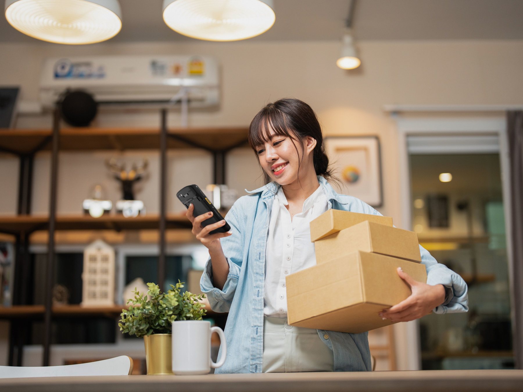 Worker scanning a shipping carton to match its applied label