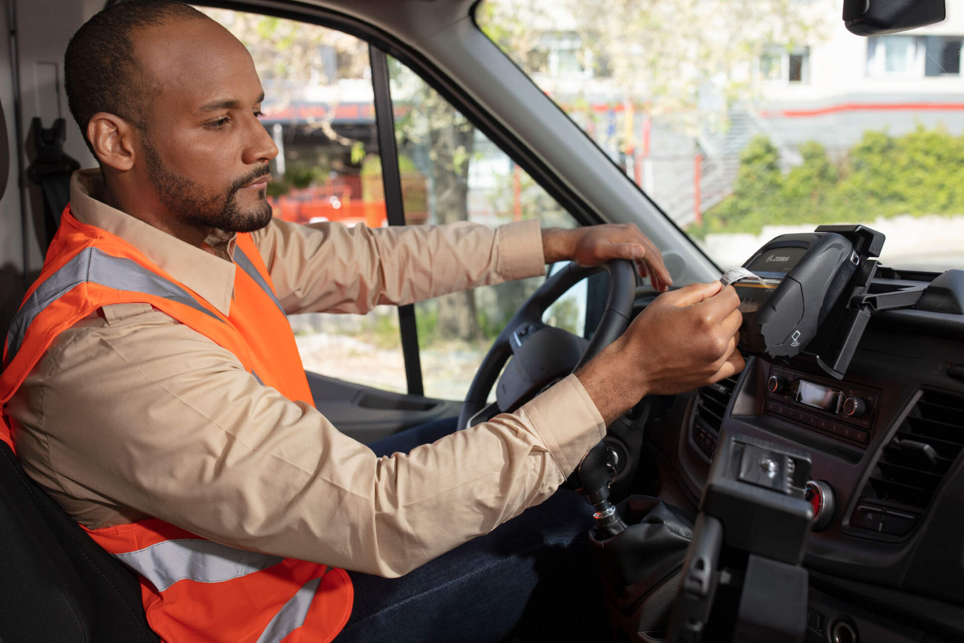 Field worker tearing a short receipt from a mobile direct thermal printer