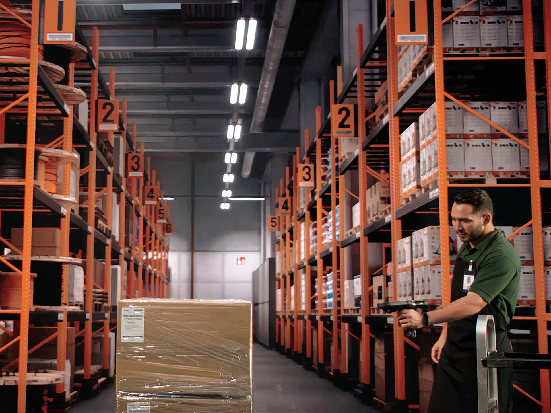 Retail stockroom worker scanning a carton with a rugged mobile computer